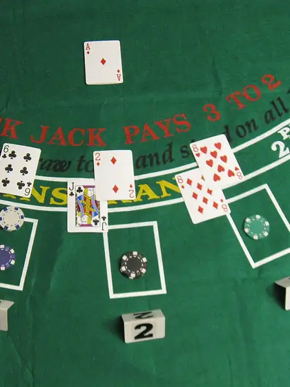 Cards and chips on a green blackjack table