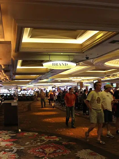 Crowd walking across a lively casino floor