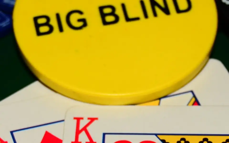 Big blind button and cards on a poker table