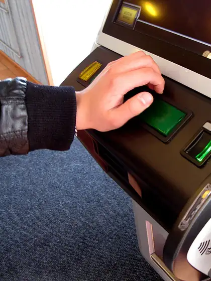 Player pressing the spin button on a slot machine